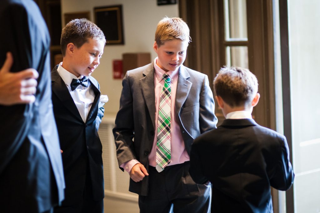 Three boys playing around before wedding ceremony 