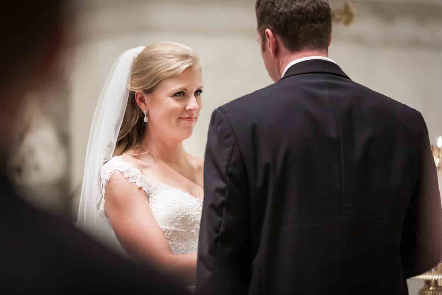 Bride listening to groom during St. Peter's Church wedding ceremony