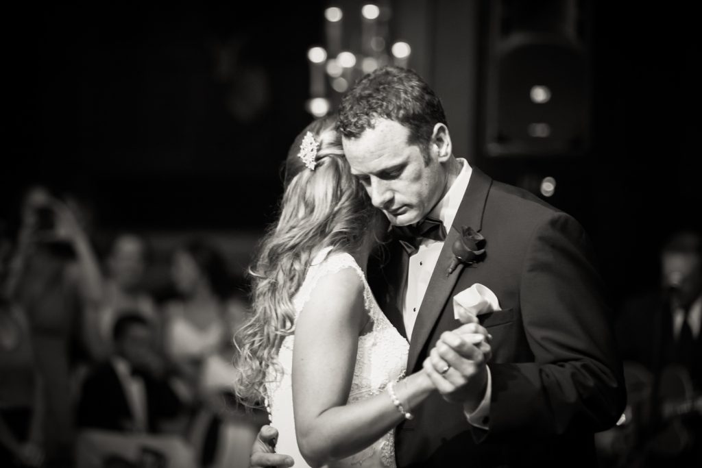 Black and white photo of groom and bride during first dance