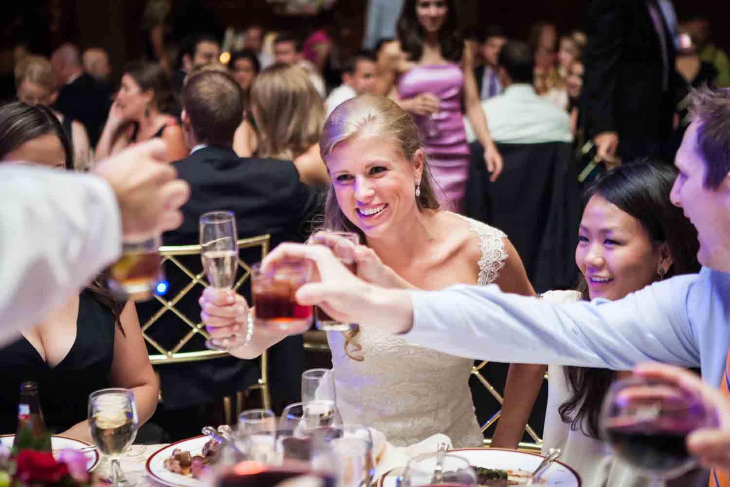 Bride raising glass with guests at a Harvard Club NYC wedding