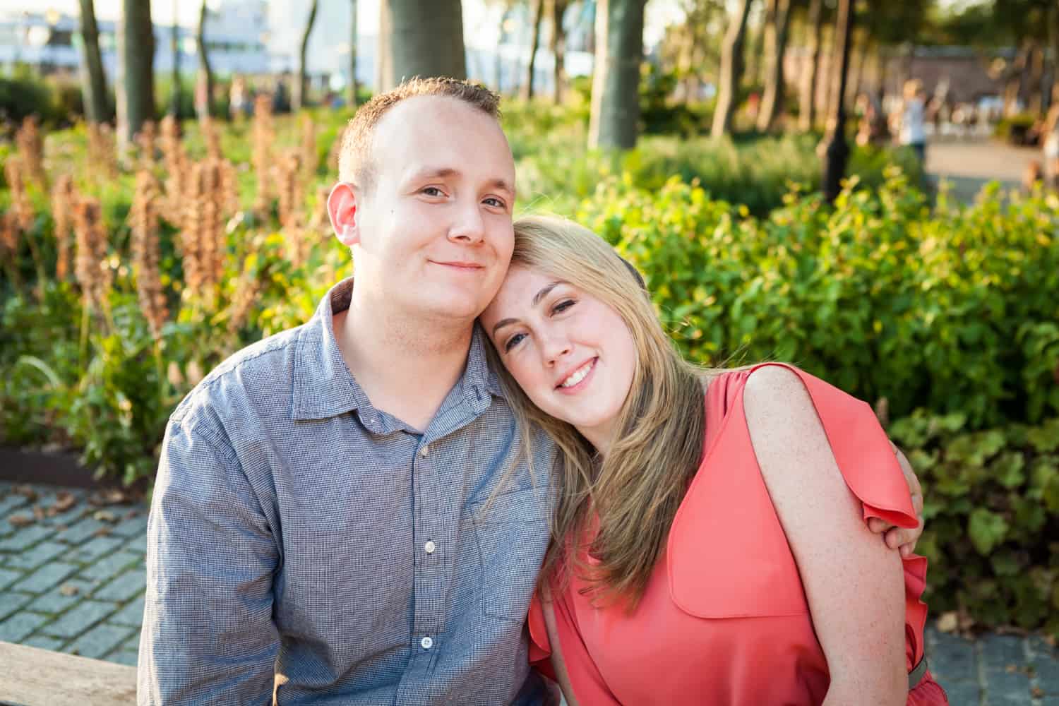 Couple sitting on bench at a Battery Park engagement shoot