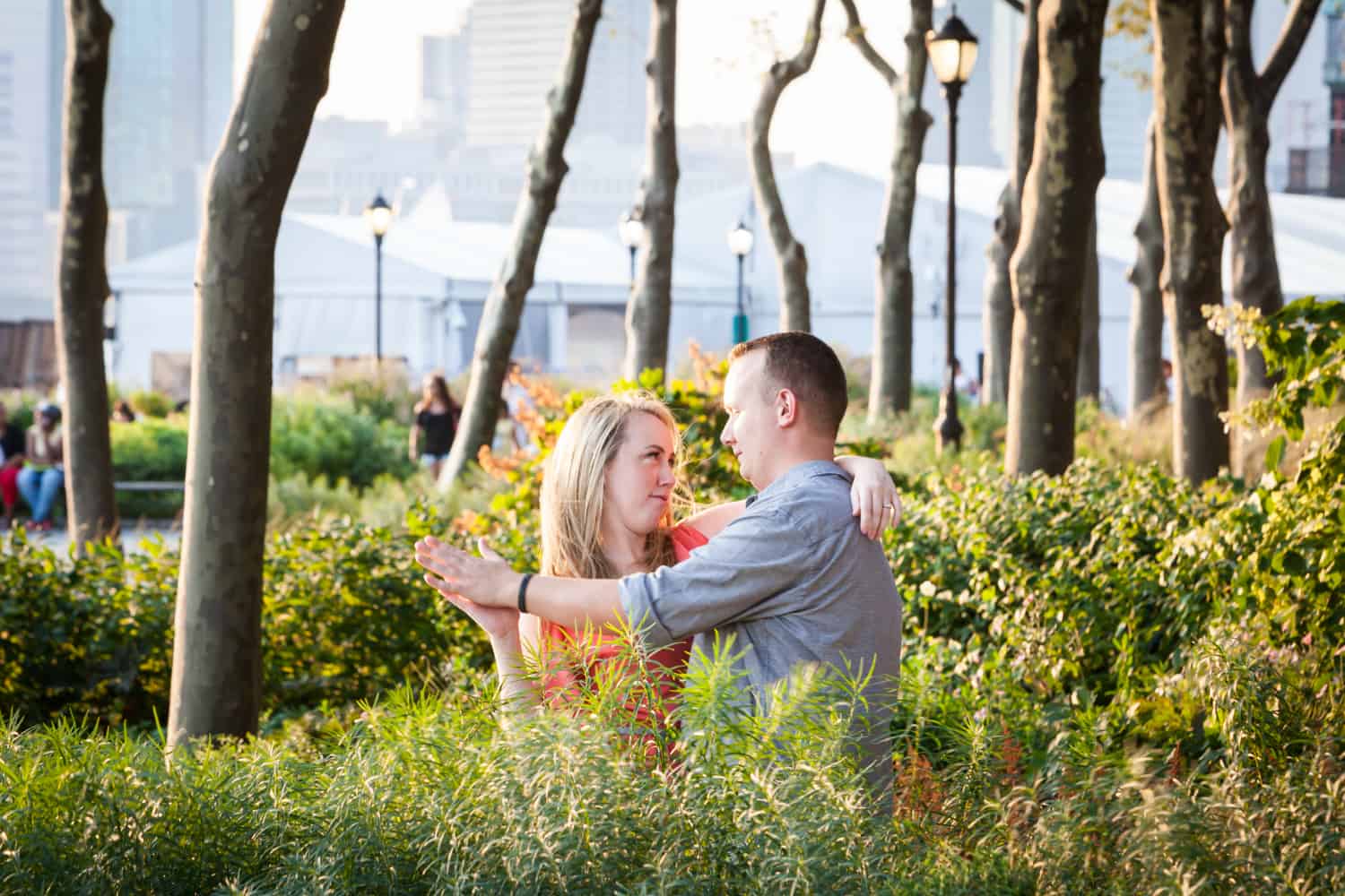 Couple dancing in park at a Battery Park engagement shoot
