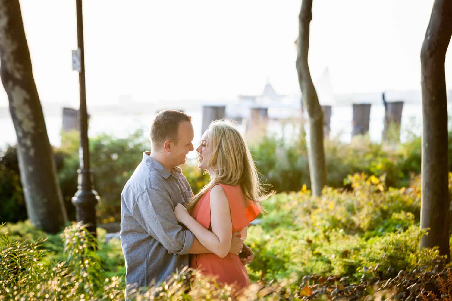 Couple hugging in middle of park at a Battery Park engagement shoot