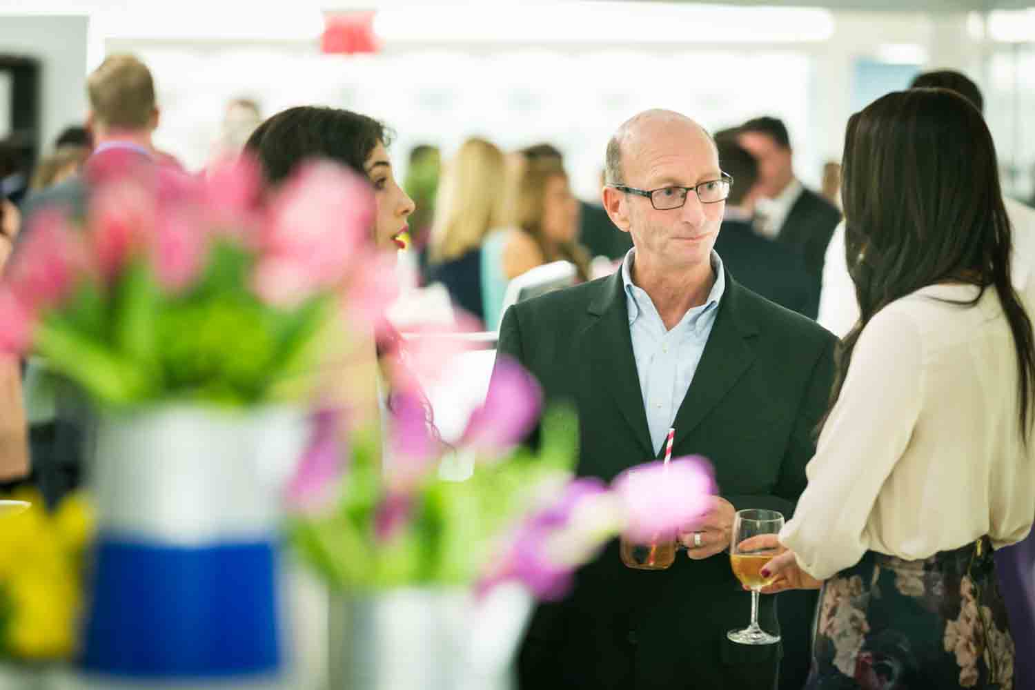 Guests talking at a corporate cocktail party for an article on corporate event planning tips