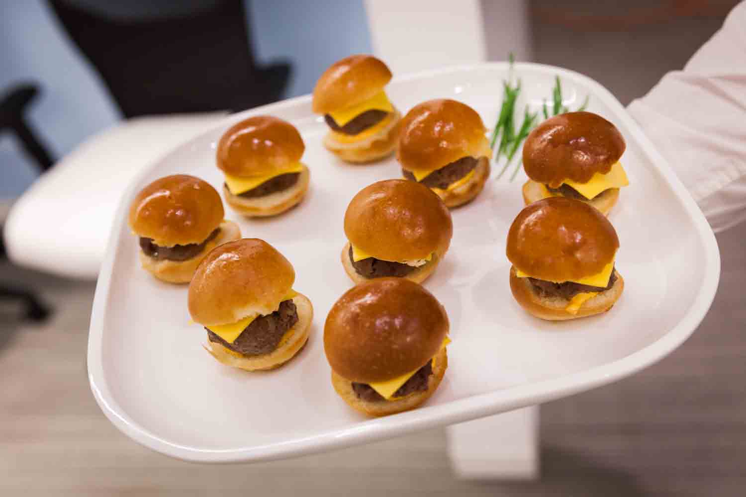 Plate of mini hamburgers served at cocktail party