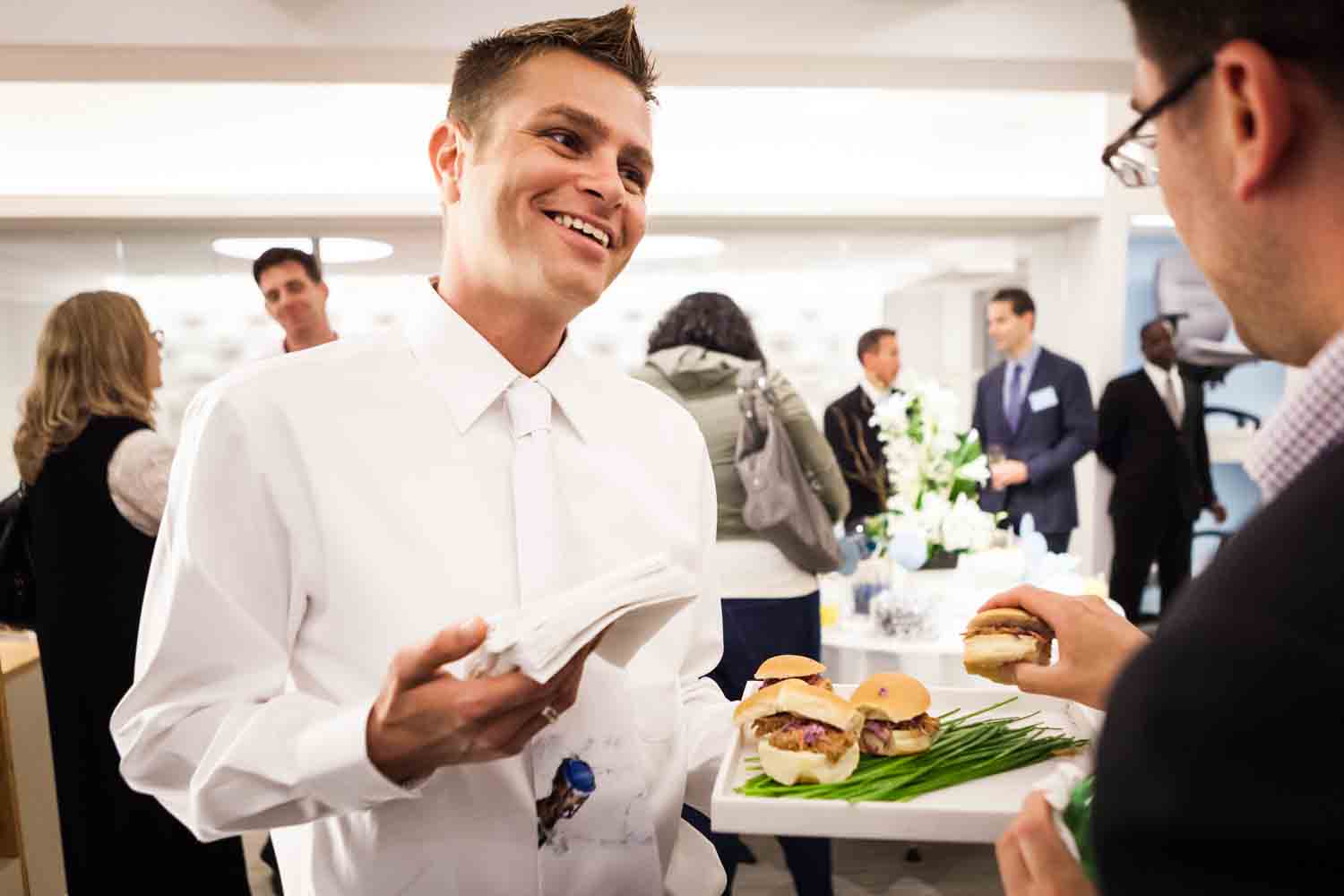 Waiter offering appetizers to a guest for an article on corporate event planning tips