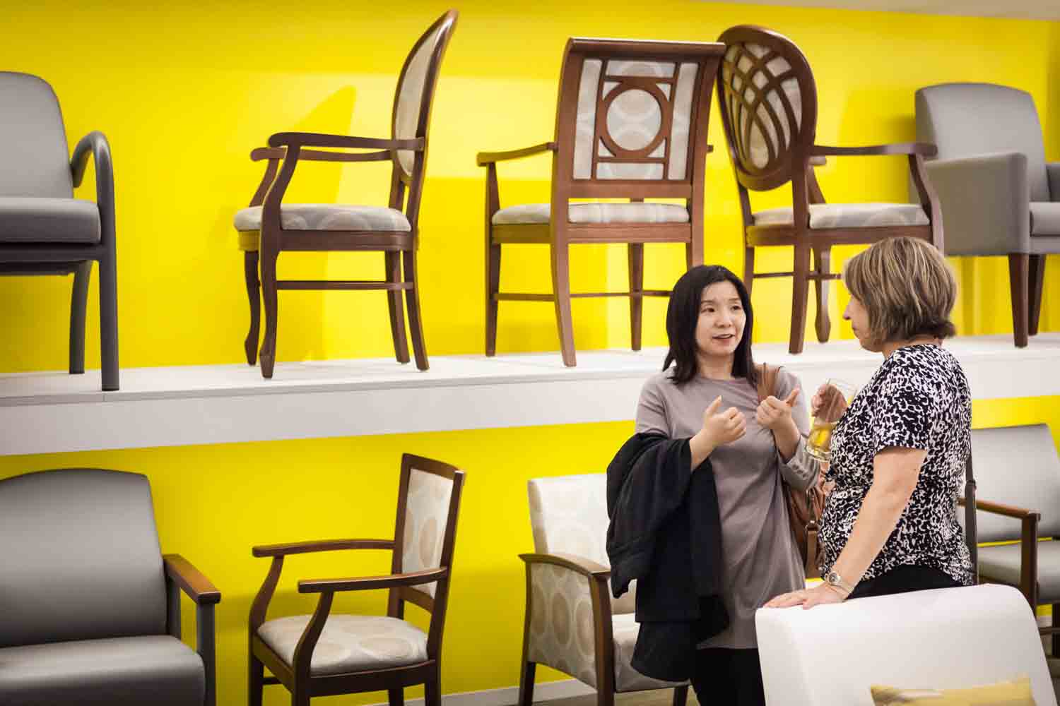 Guests talking in front of row of chairs at a corporate cocktail party for an article on corporate event planning tips