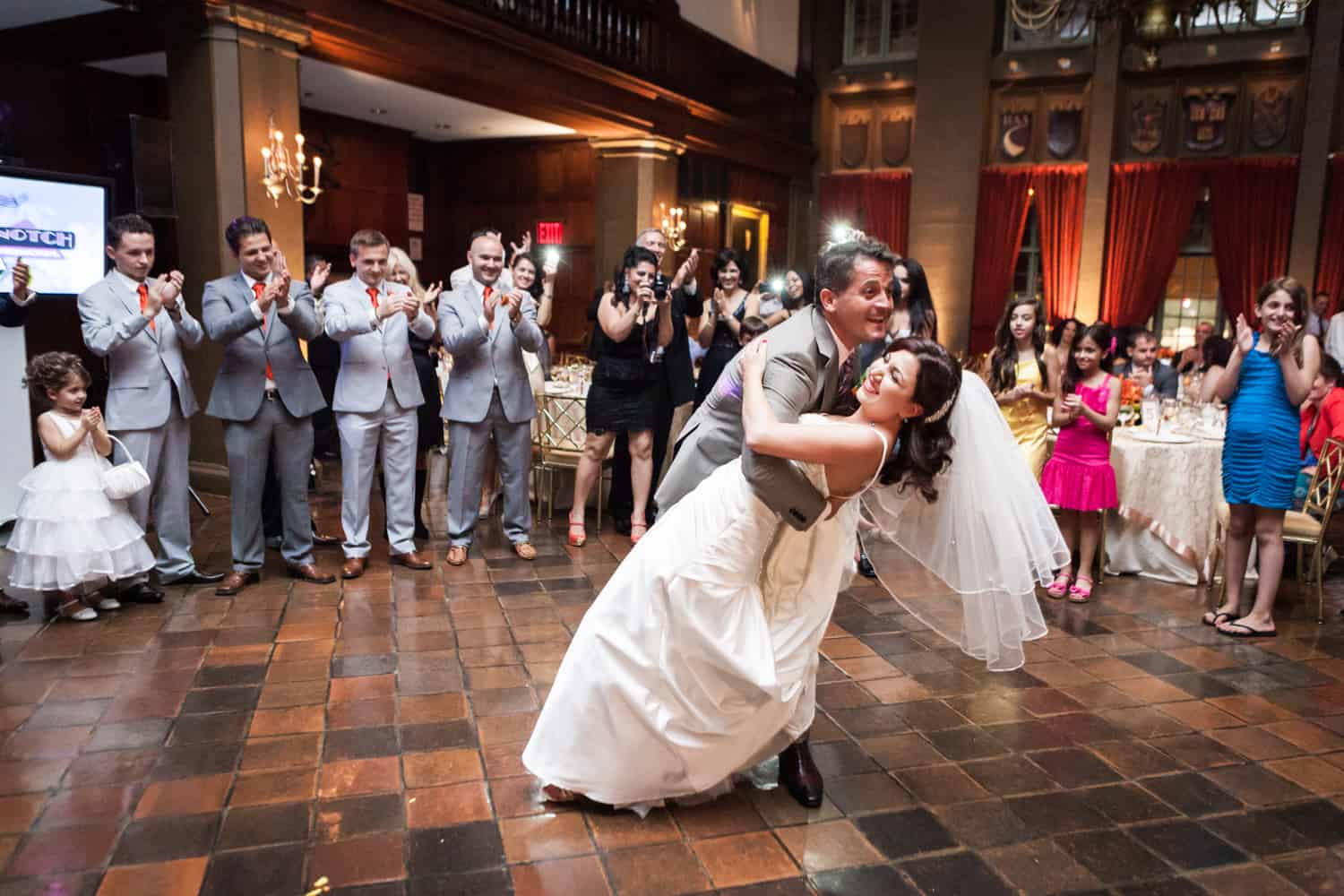 Groom dipping bride during first dance at a Harvard Club wedding