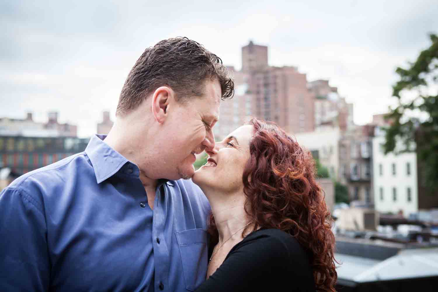High Line engagement photos of couple with view of Meatpacking District in the background