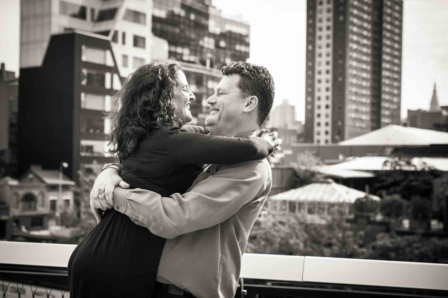 Black and white photo of man lifting up woman on the High Line