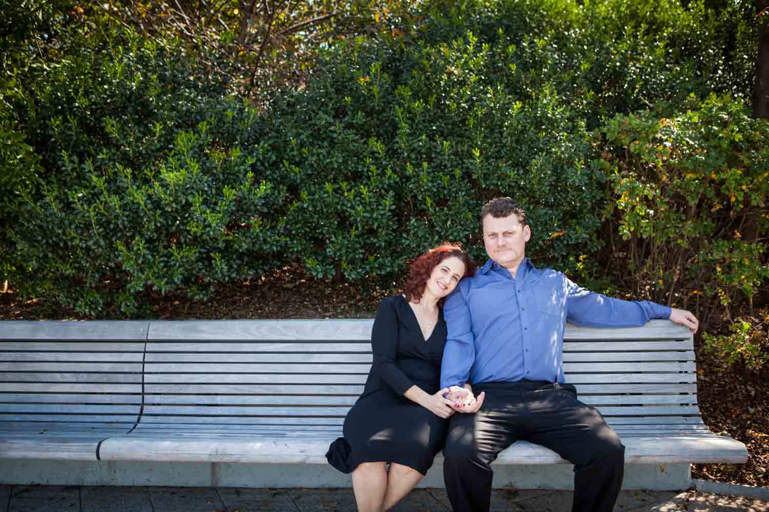 Couple sitting together on bench in park