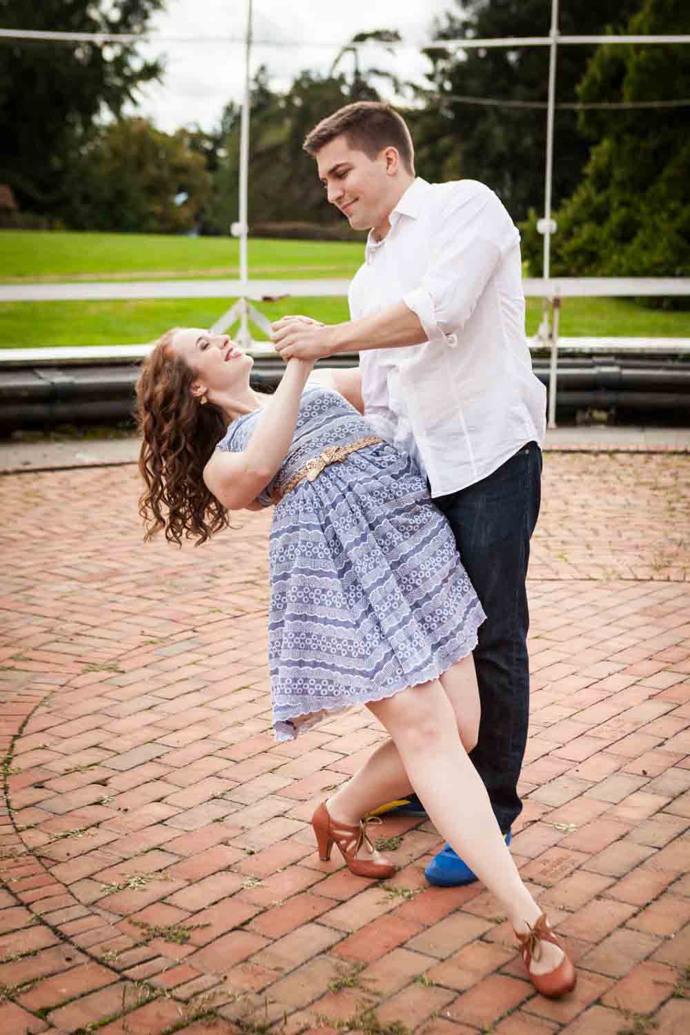Couple dancing on brick patio at a Lyndhurst Mansion engagement photoshoot