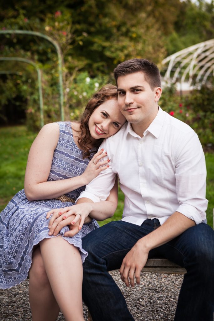 Couple sitting on bench at a Lyndhurst Mansion engagement photoshoot