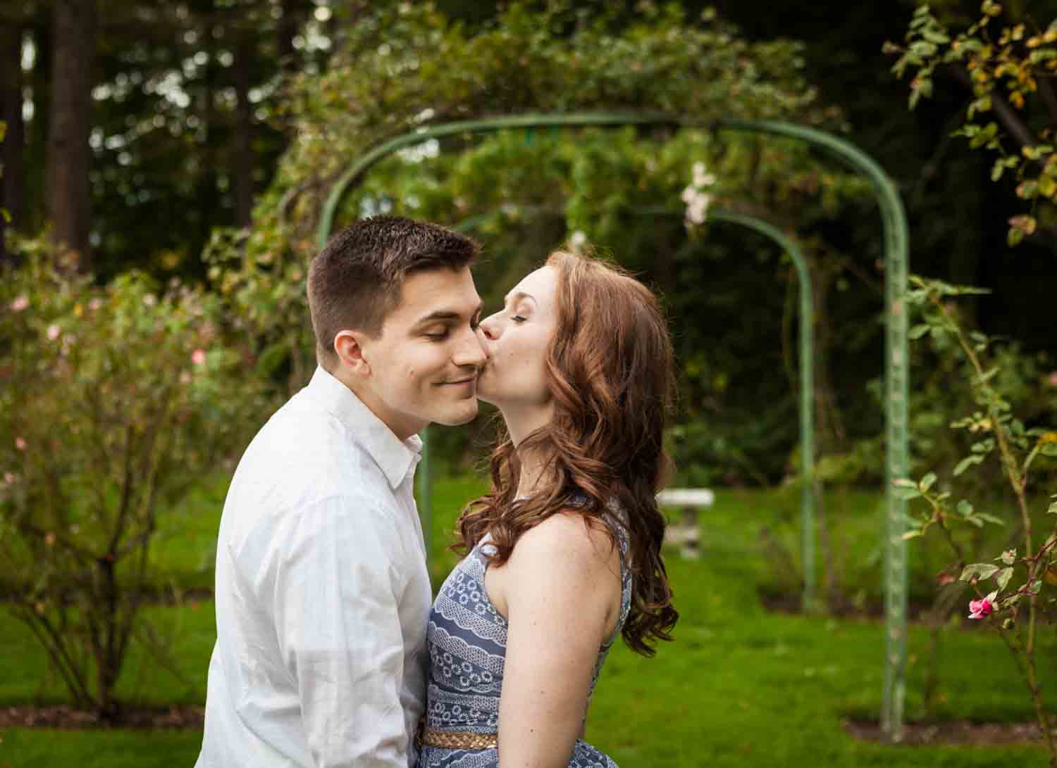 Woman kissing man on cheek at a Lyndhurst Mansion engagement photoshoot