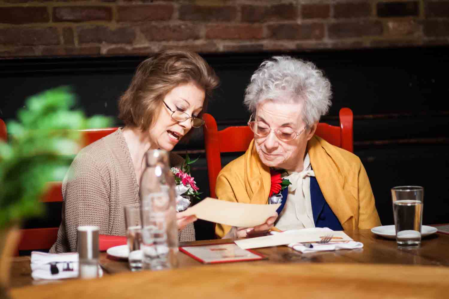 Mother and grandmother looking at menu at Tribeca reception