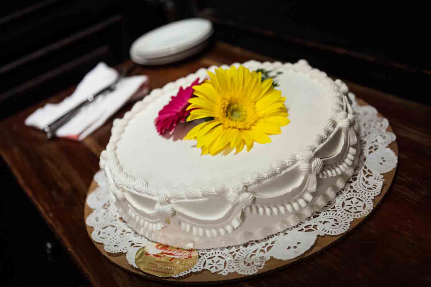 Close up on one-layer wedding cake with flowers on top