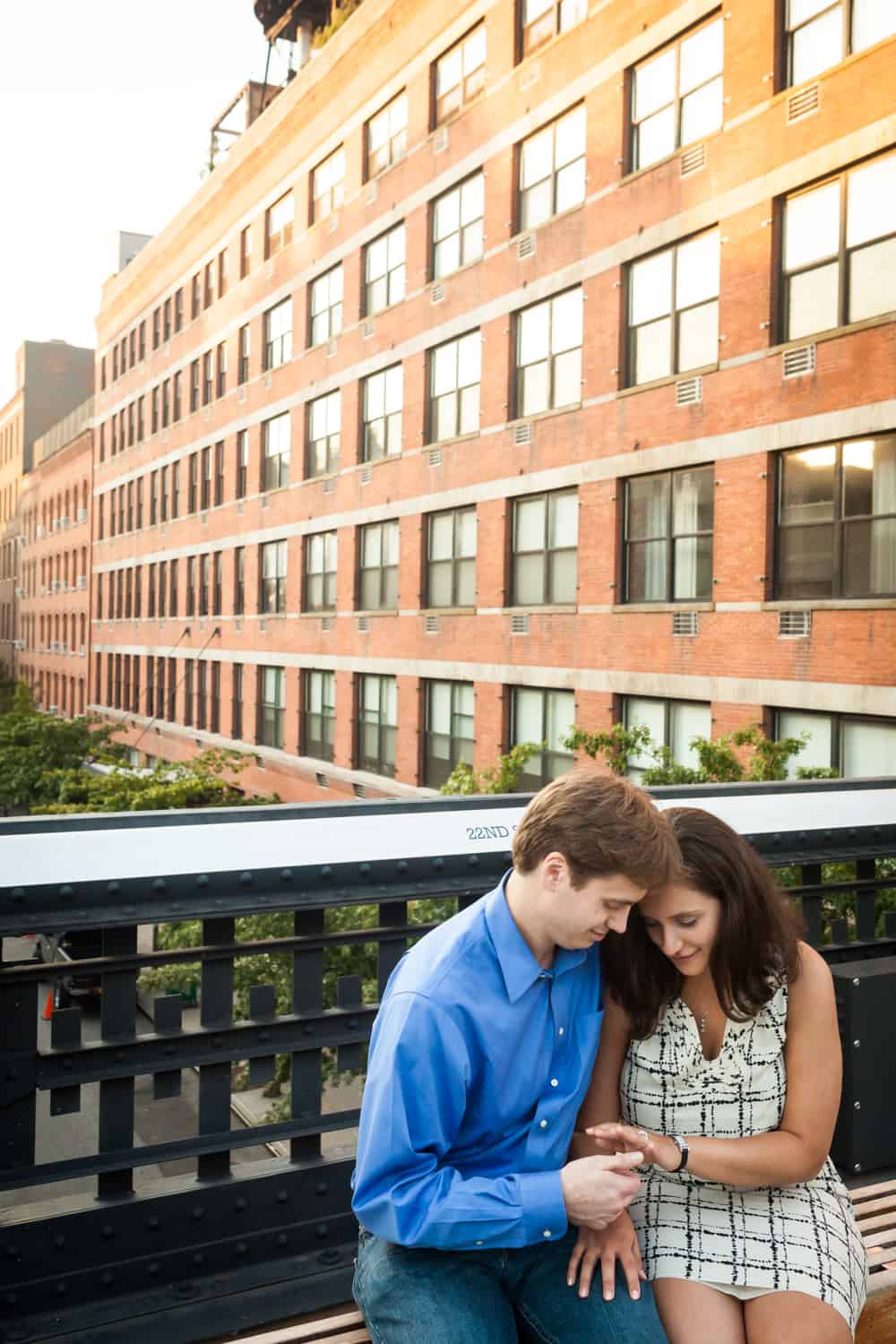 Couple looking down at engagement ring during High Line engagement session