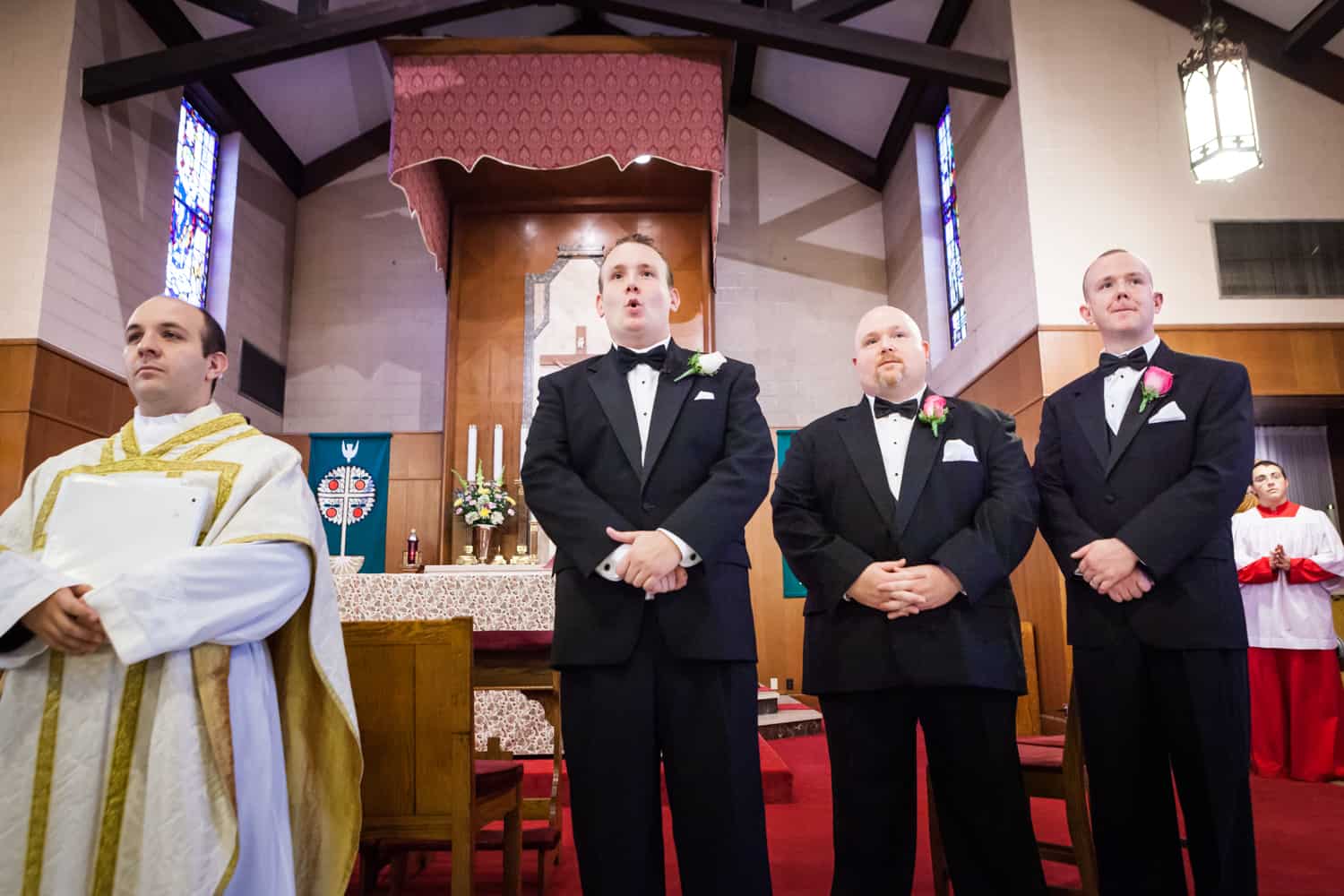 Groom and groomsmen waiting for bride to walk down the aisle
