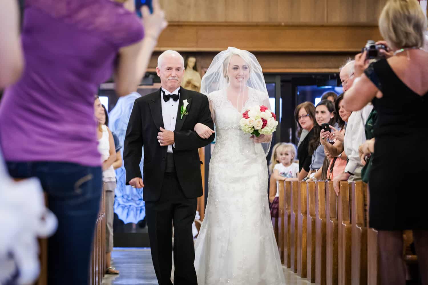 Bride and father walking down aisle for ceremony