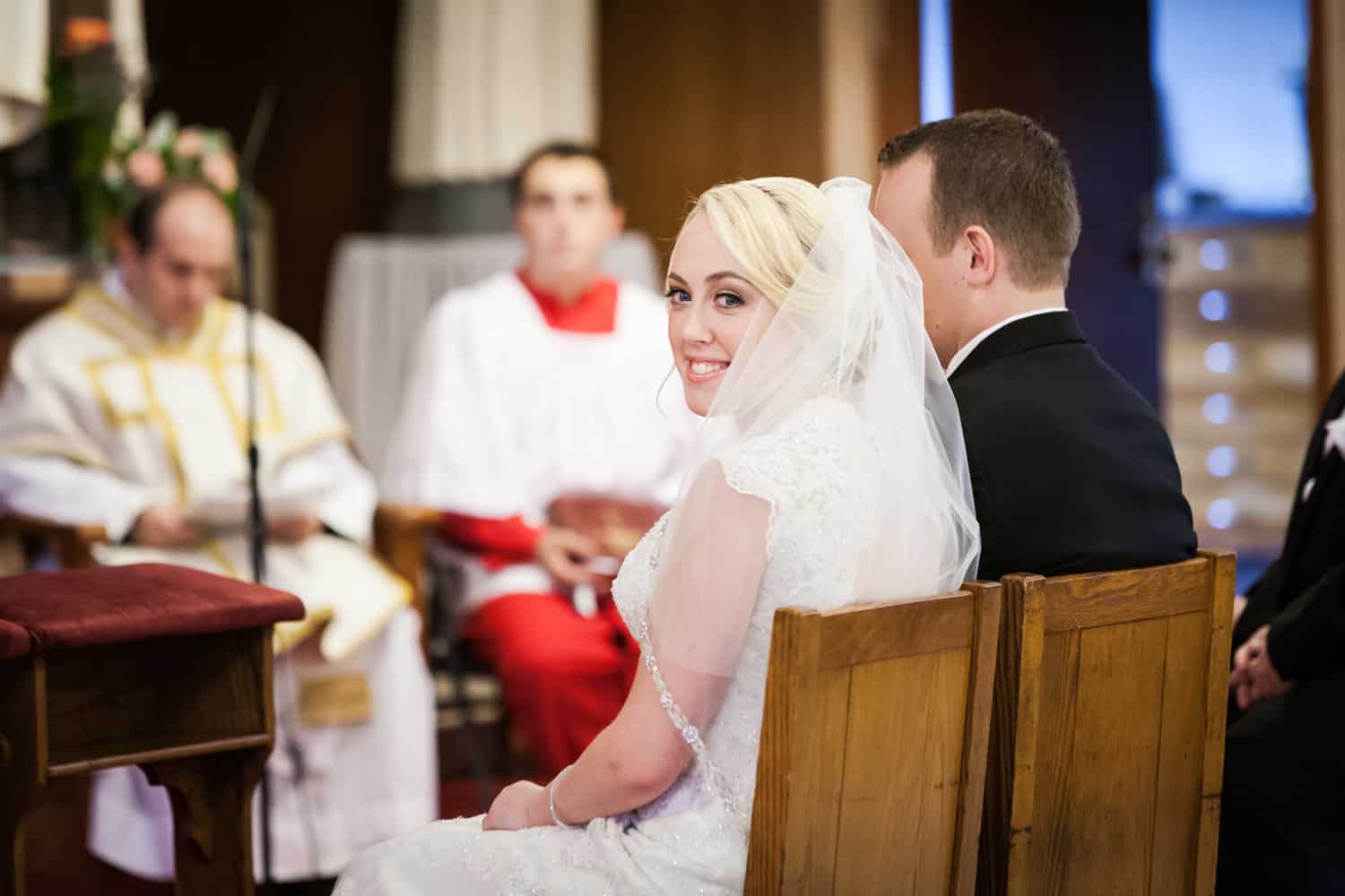 Bride looking over shoulder during wedding ceremony