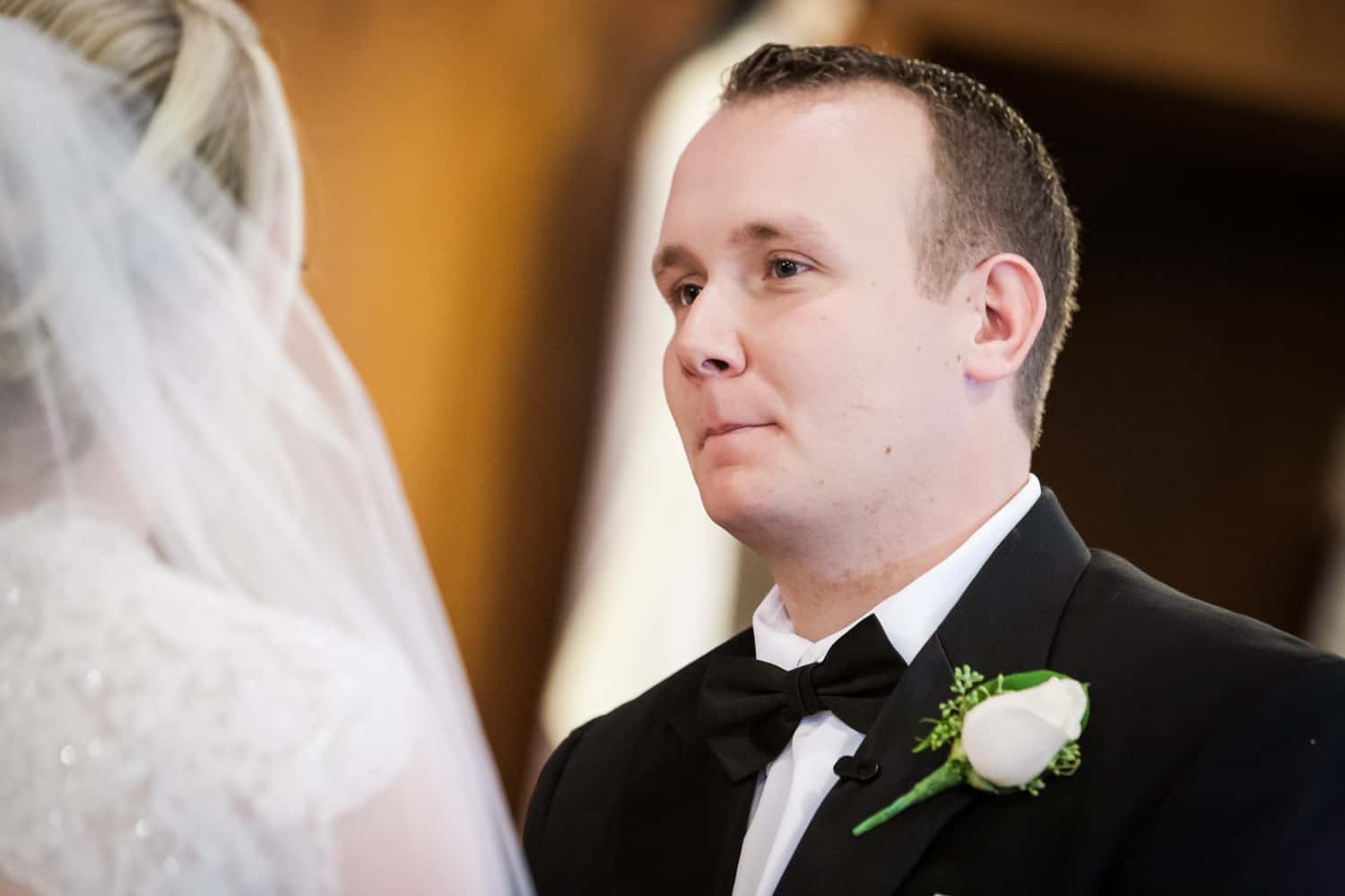 Groom looking at bride during wedding ceremony