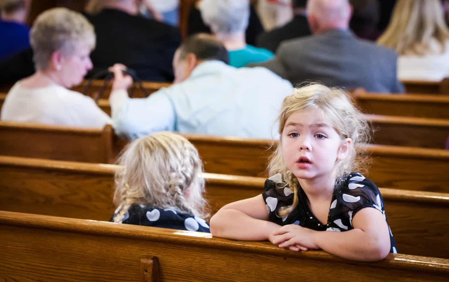 Little girl turned around in pew during wedding ceremony