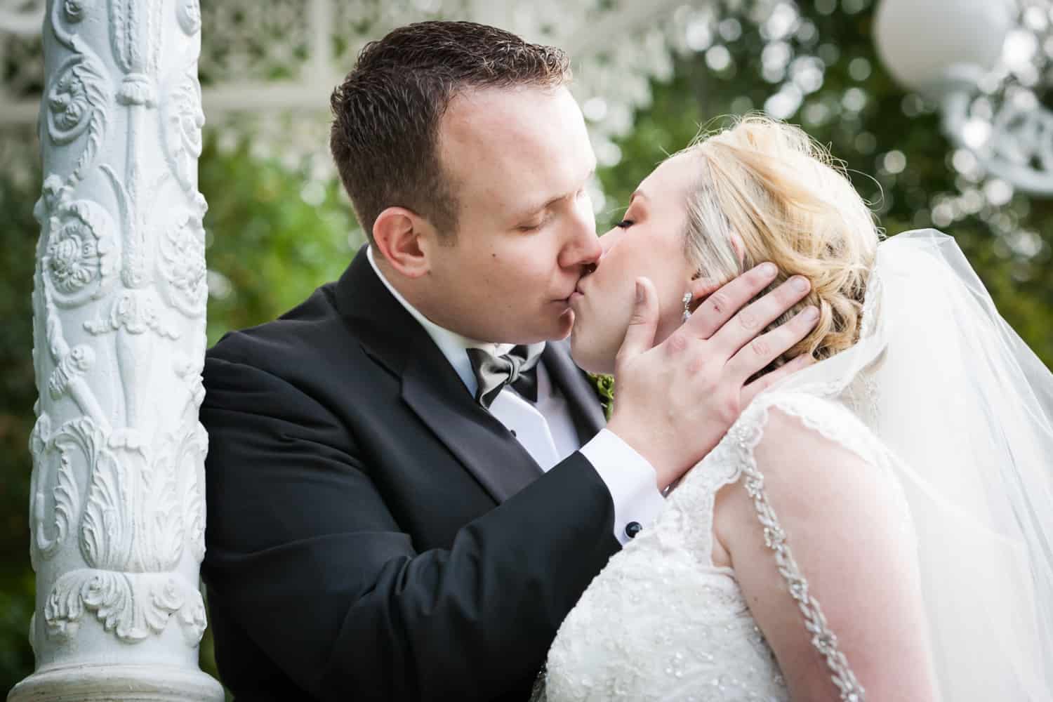 Bride and groom kissing in gazebo at a Nicotra's Ballroom wedding