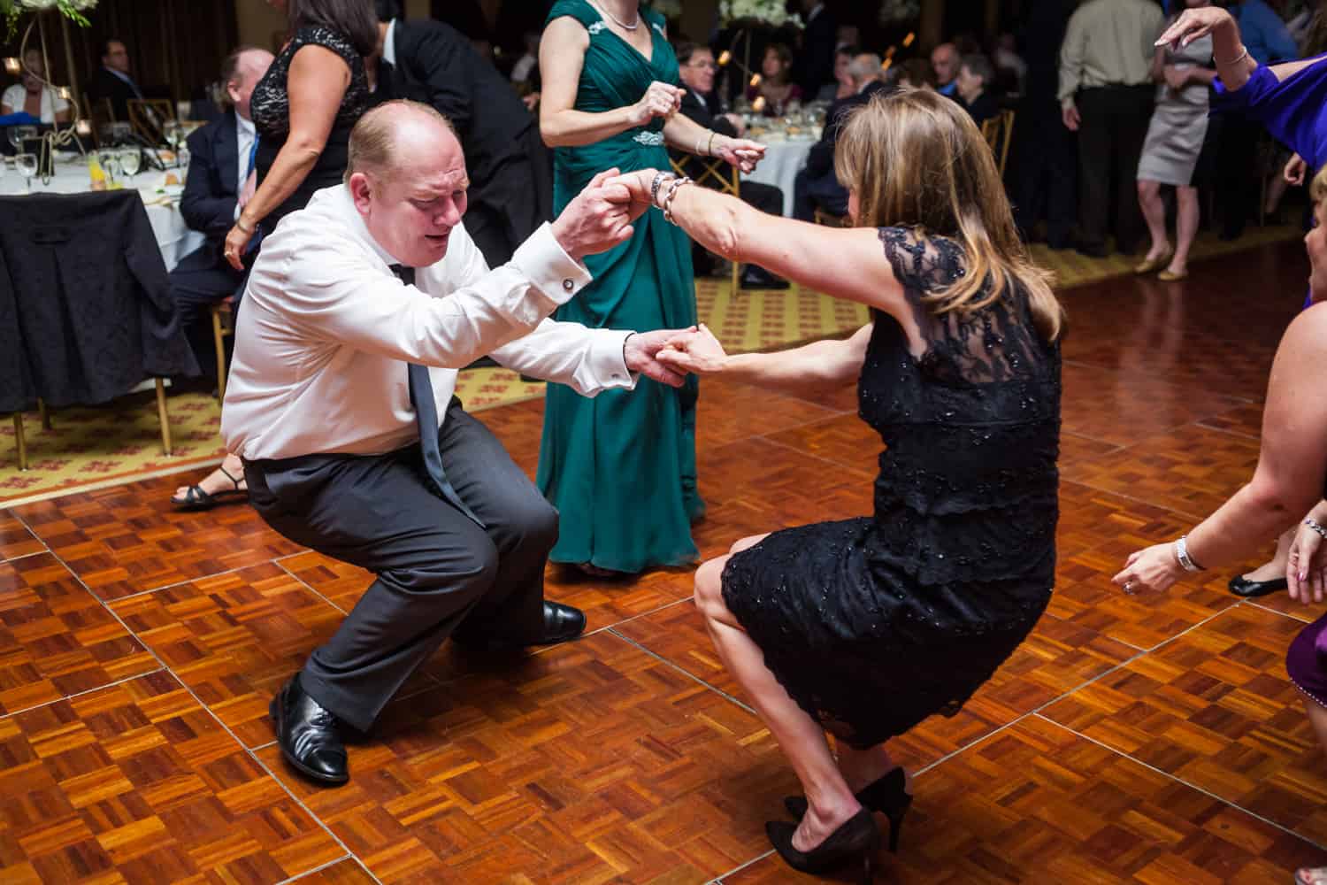 Two guests dancing low to the floor at a Nicotra's Ballroom wedding