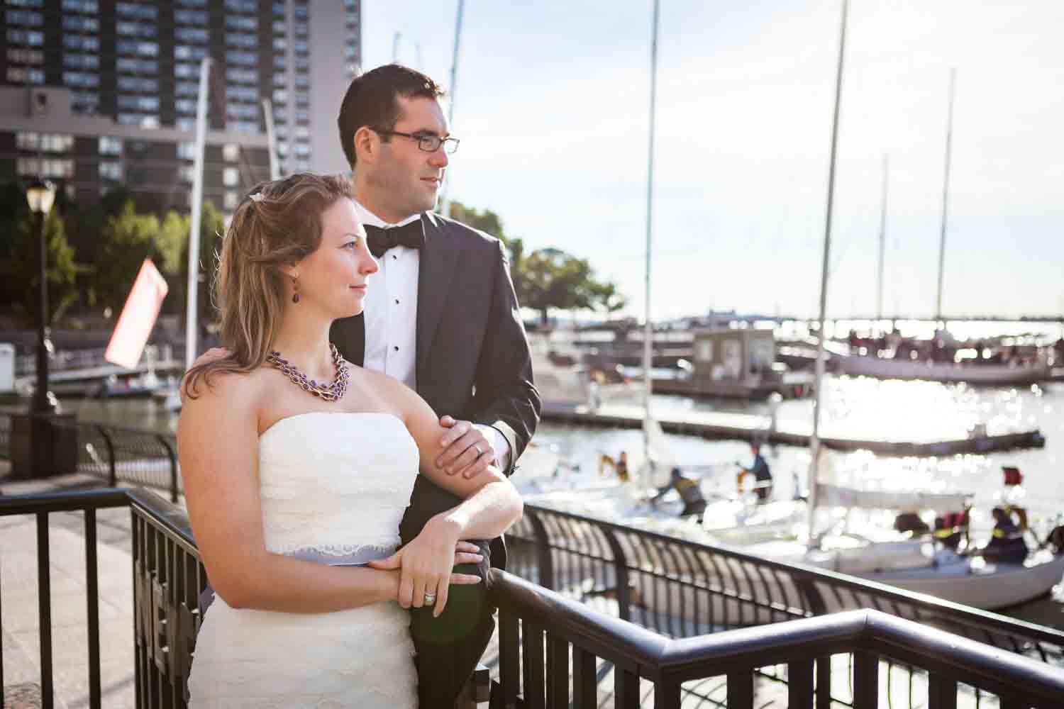 Bride and groom in front of marina at a trash the dress shoot
