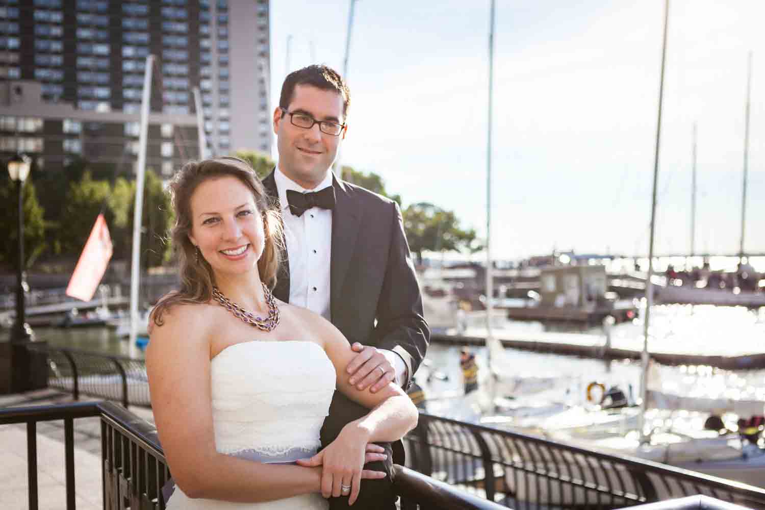 Bride and groom in front of marina at a trash the dress shoot