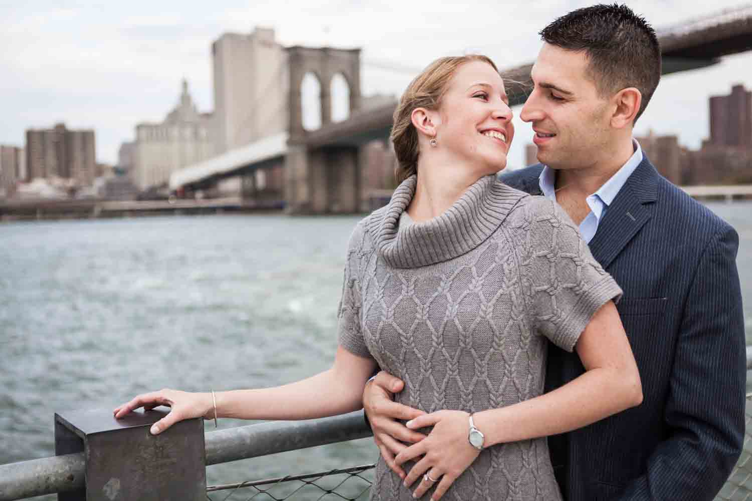 Couple hugging with Brooklyn Bridge in background