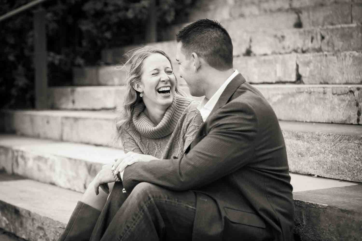 Black and white photo of woman laughing with man