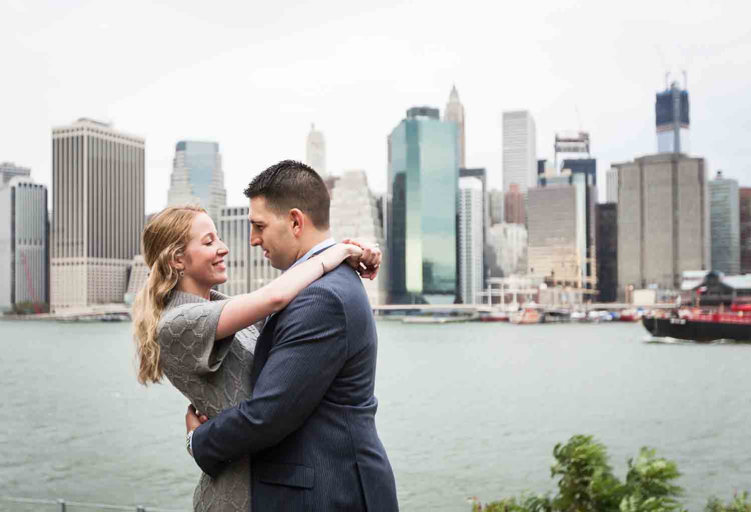 Couple looking at each other with NYC skyline in background