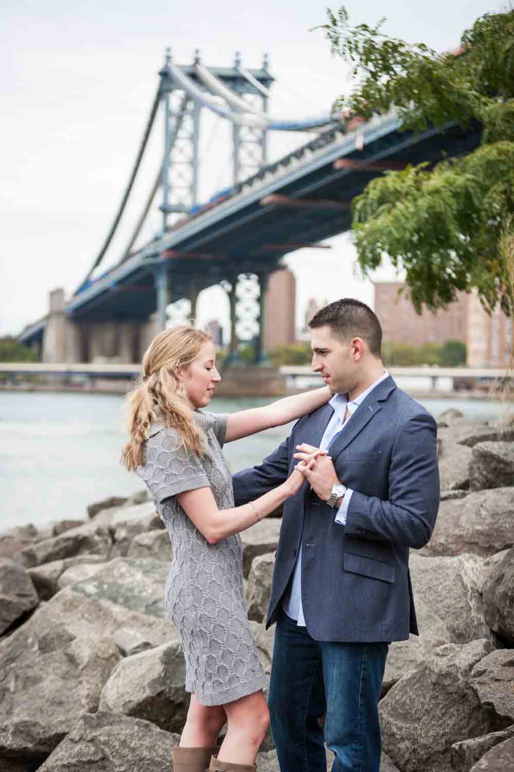 Couple dancing in Brooklyn Bridge Park with Manhattan Bridge in background