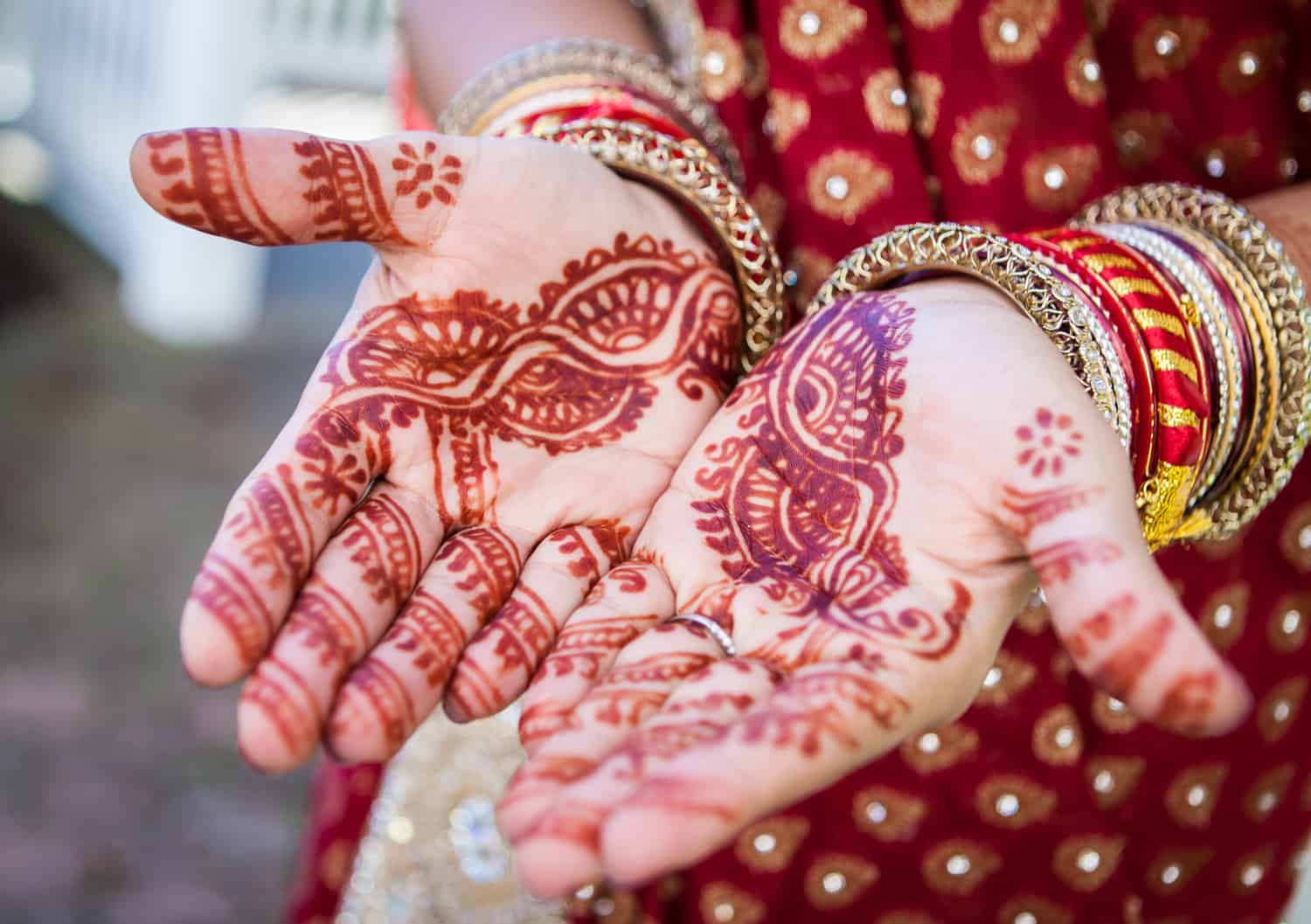 Close up on bride's hands with traditional henna design on skin