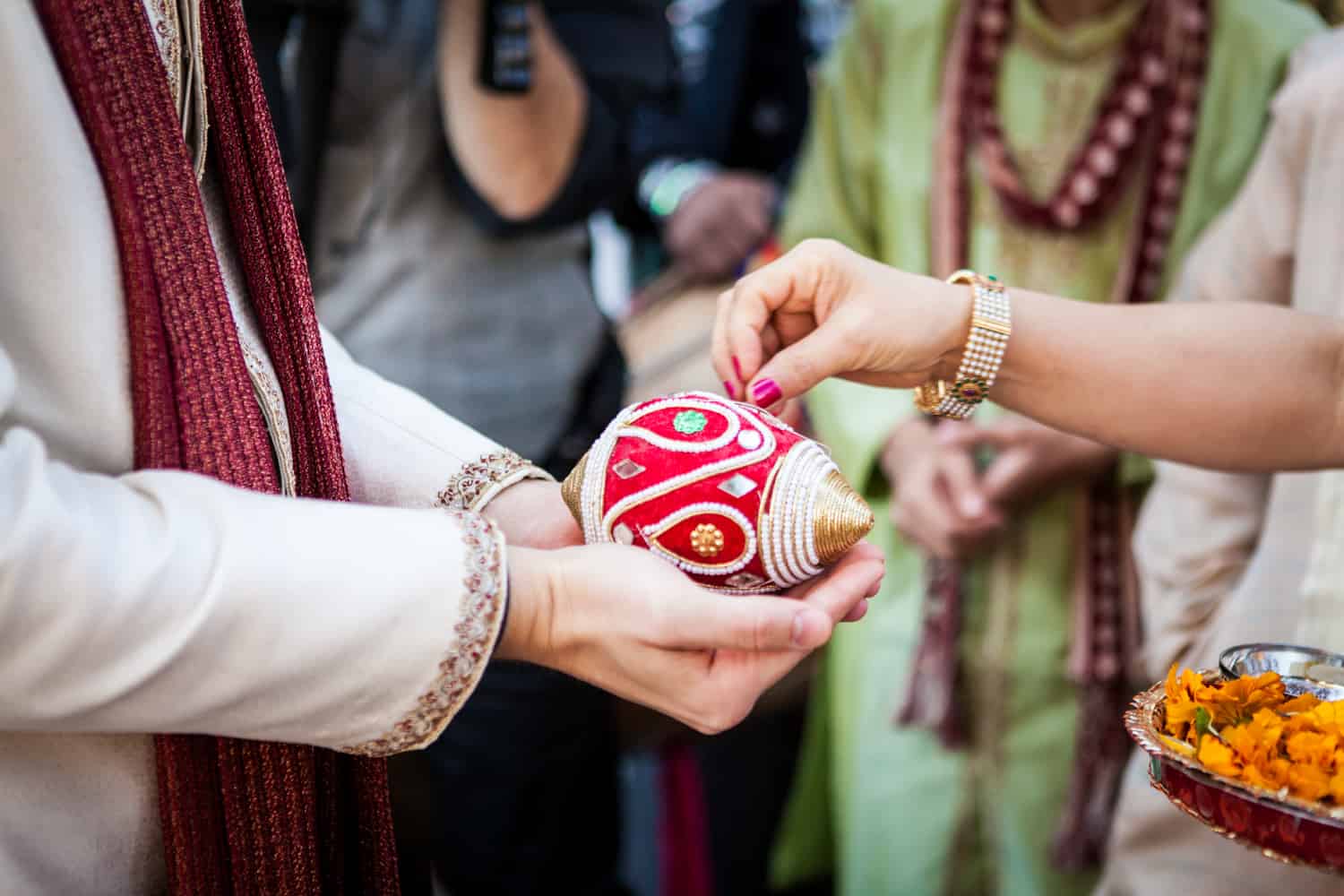 Close up on groom's hands during traditional Indian baraat