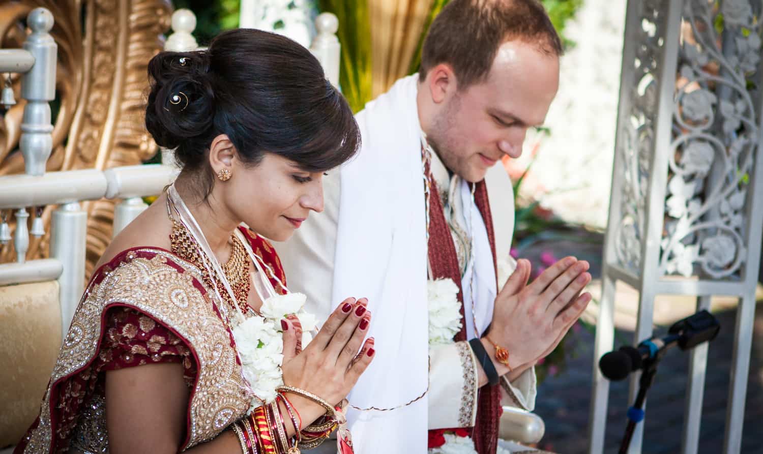Bride and groom praying during traditional Hindu wedding ceremony