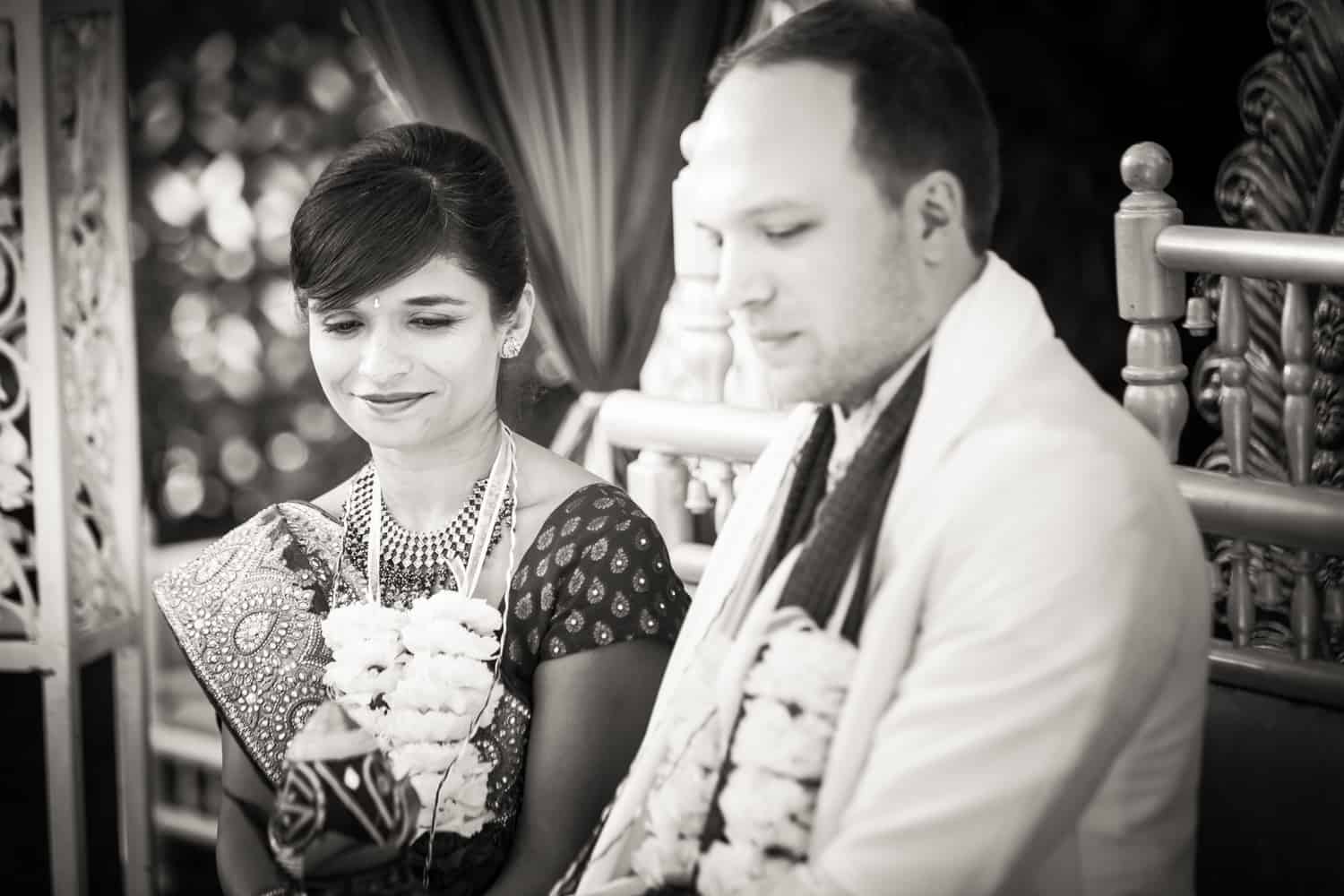 Black and white photo of bride and groom during traditional Hindu wedding ceremony