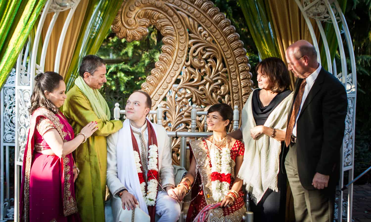 Parents speaking to bride and groom during traditional Hindu wedding ceremony