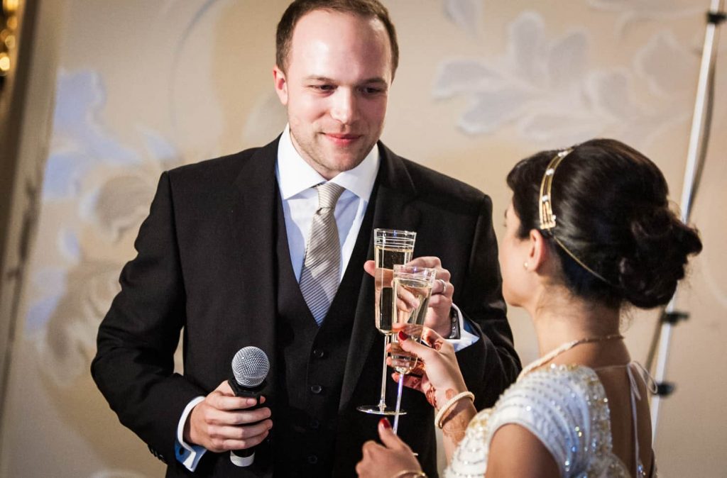 Bride and groom toasting champagne glasses at an East Wind Inn wedding reception
