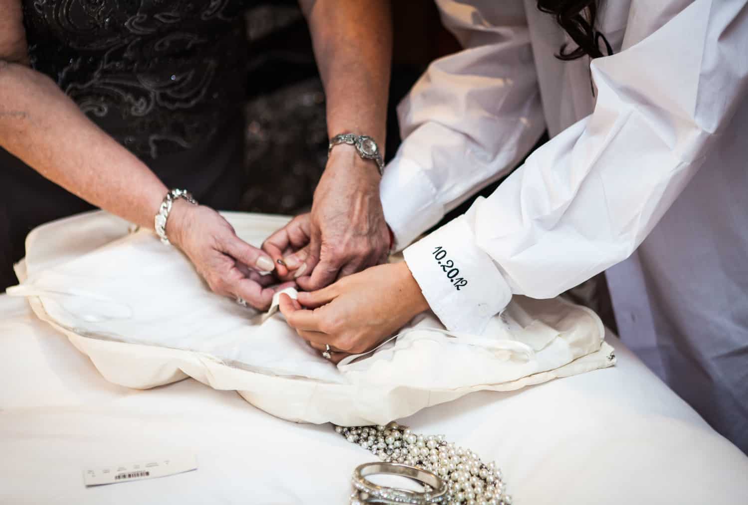 Hands fixing wedding dress