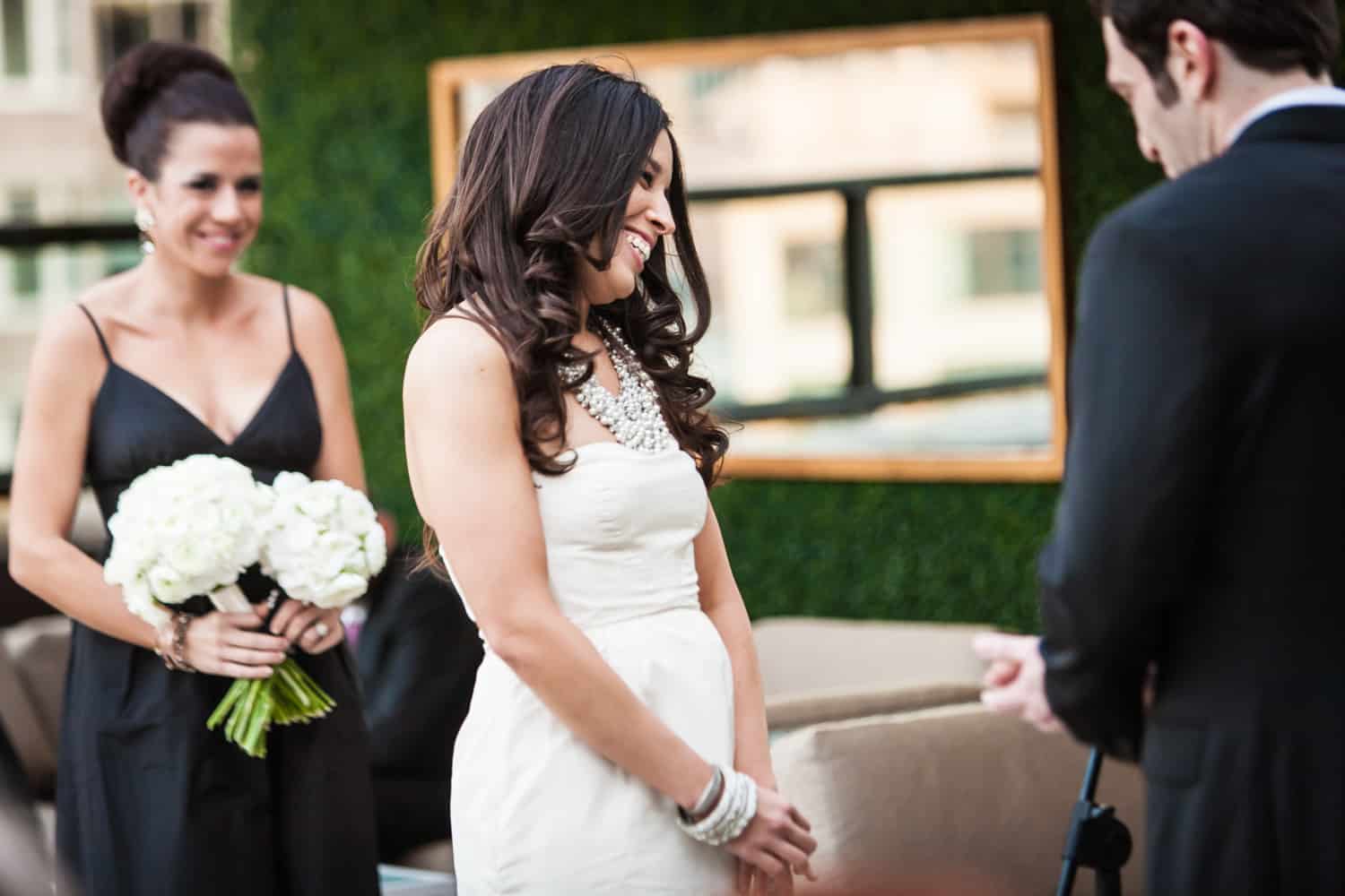Bride smiling during ceremony at an Empire Hotel rooftop wedding
