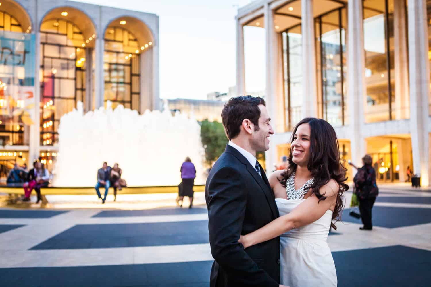 Bride and groom standing in front of Lincoln Center