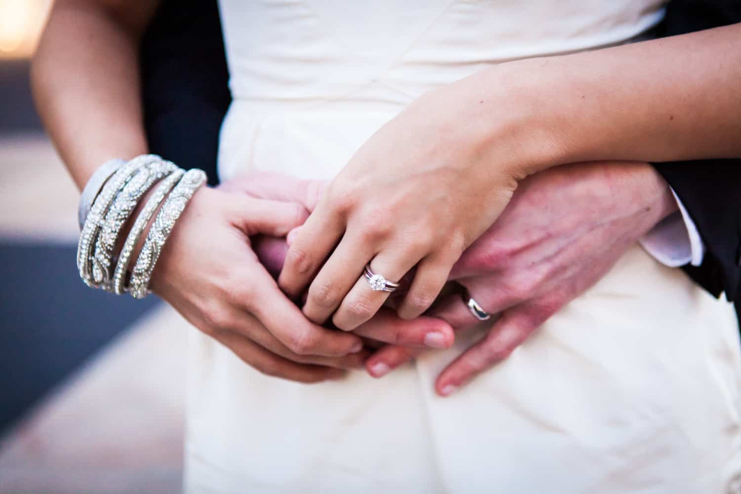 Close up on couple's hands wearing wedding rings