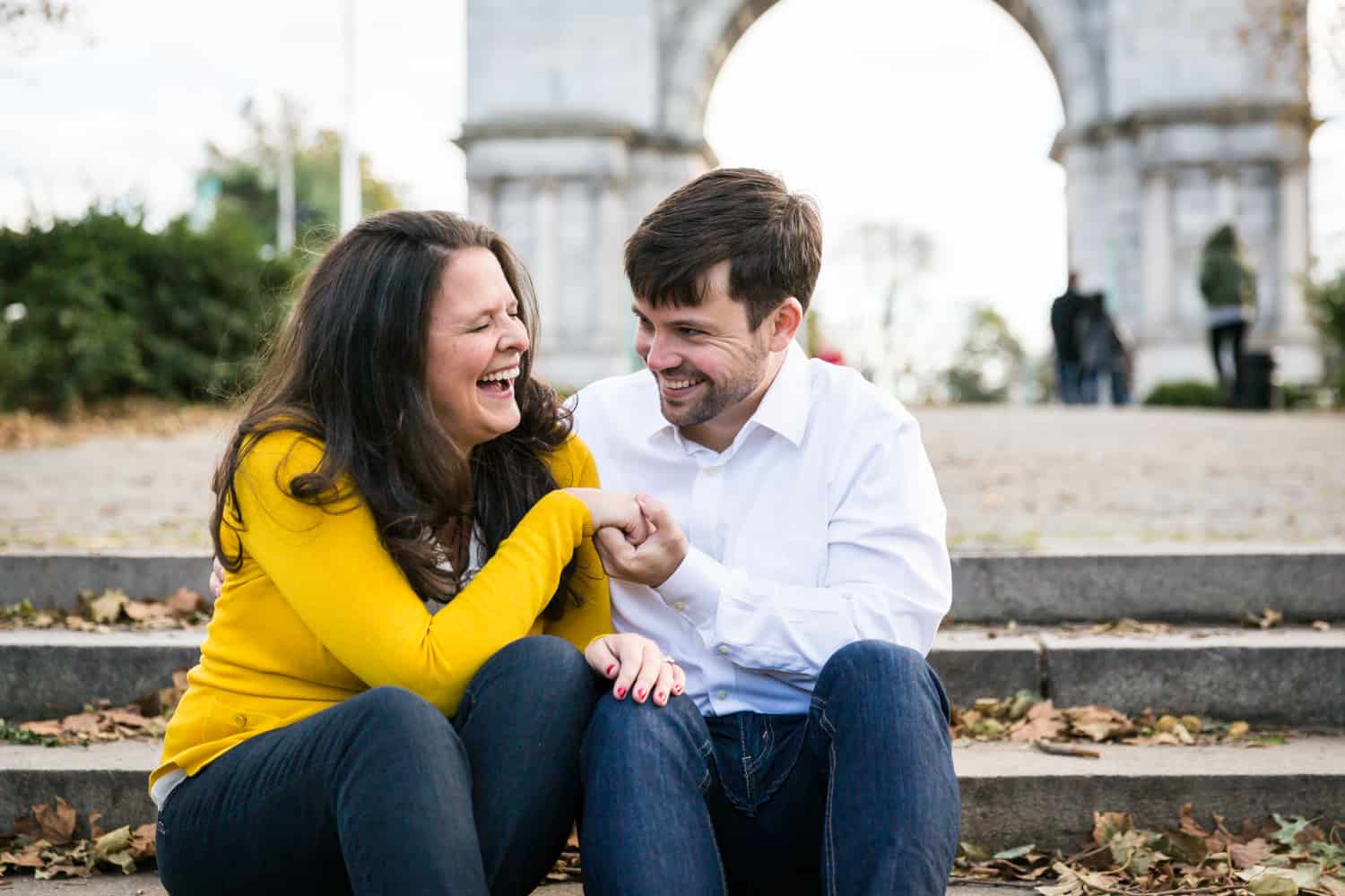 Grand Army Plaza engagement photos of couple sitting on steps