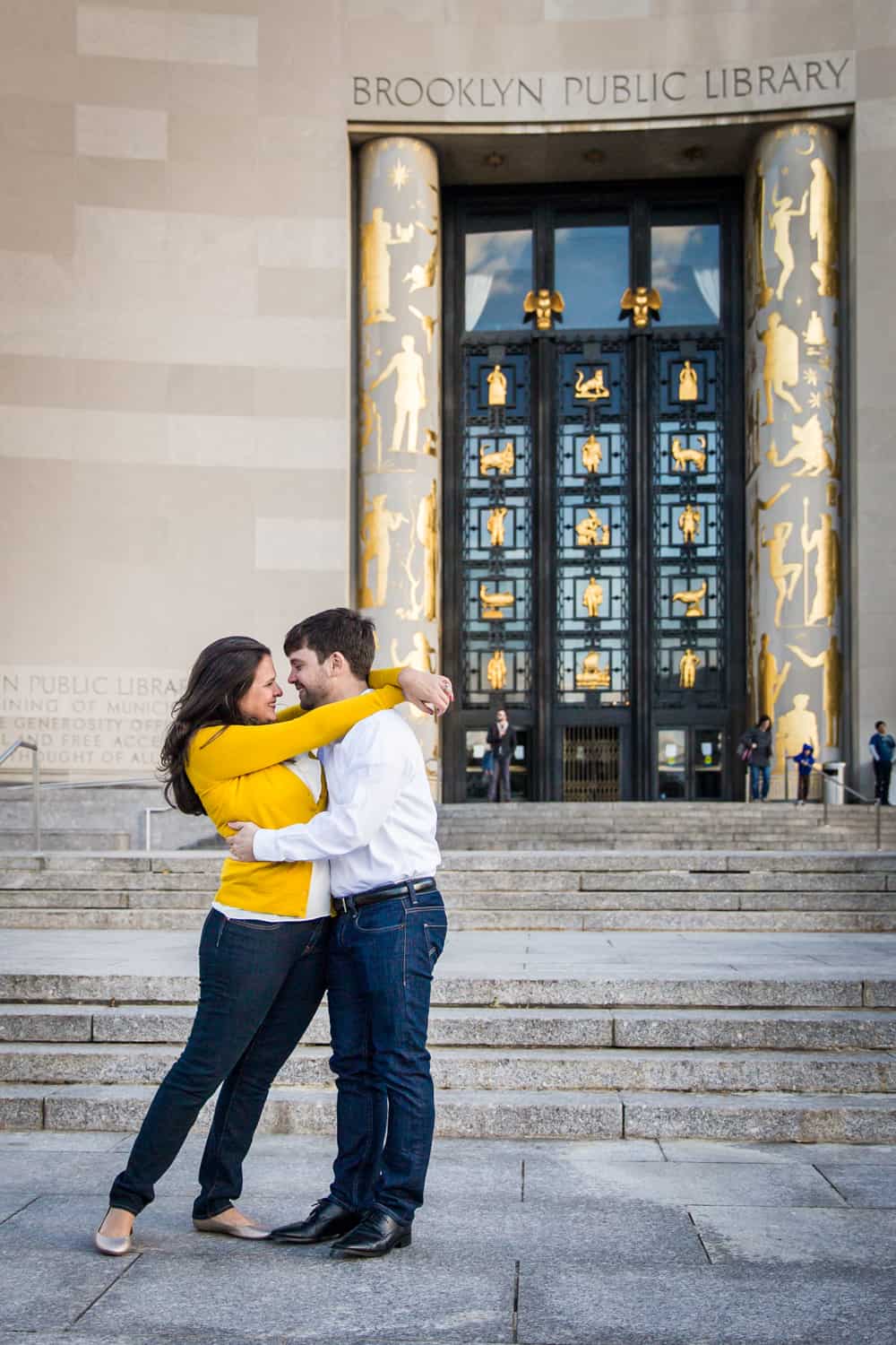 Couple hugging in front of Brooklyn Library