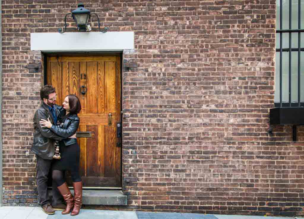 Couple in front of wooden door in Washington Mews during a Greenwich Village engagement session