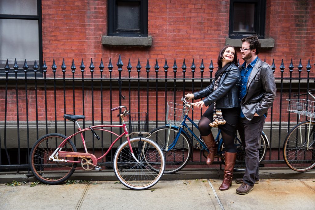 Couple on bicycle on sidewalk in Greenwich Village