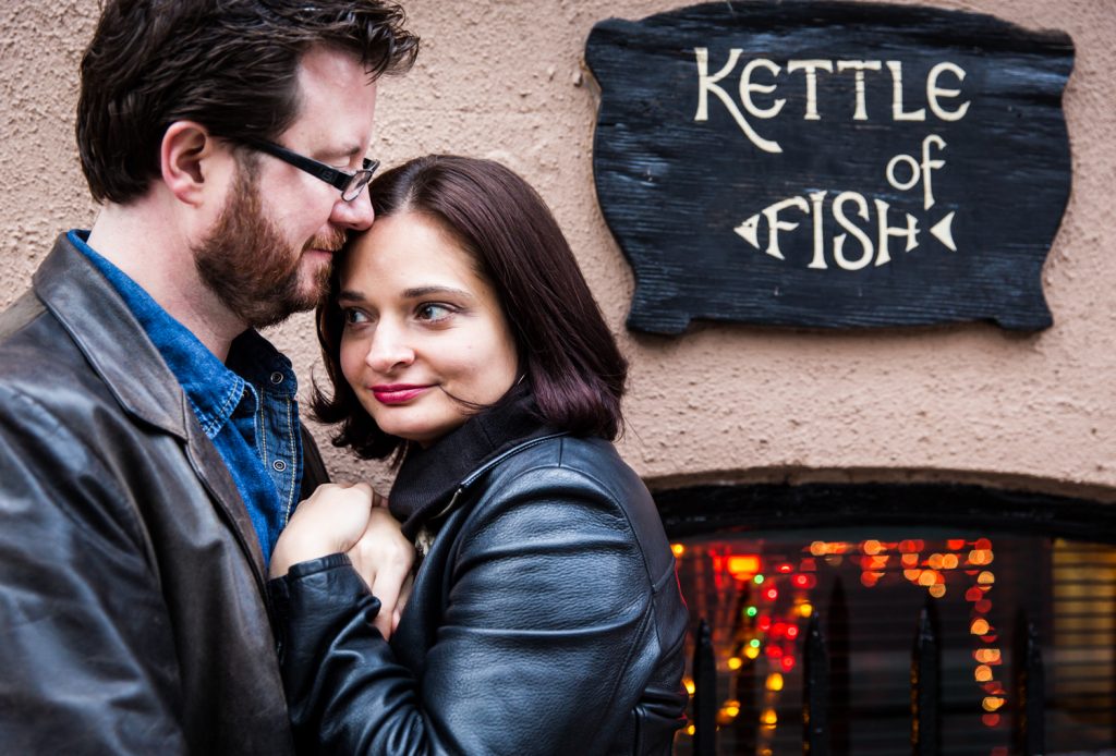 Couple kissing by Kettle of Fish sign