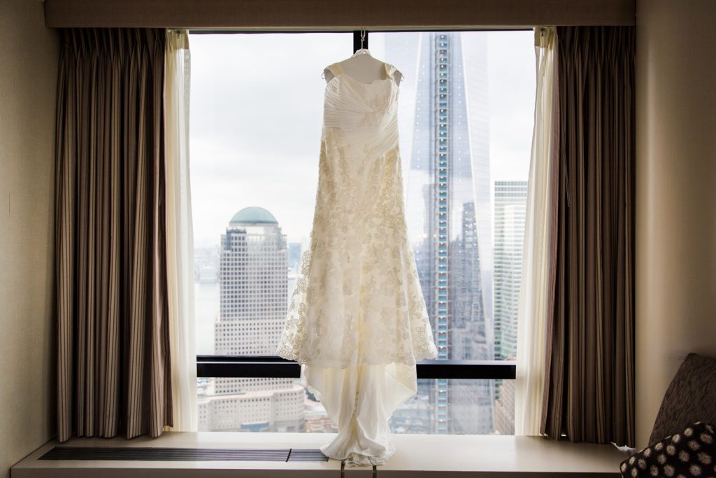 Wedding dress hanging in a hotel window for a Locanda Verde wedding